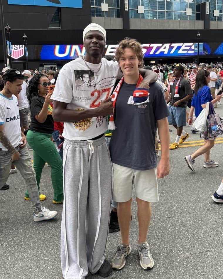 Tichyque and his younger brother Nick, arm in arm outside a U.S. national team match in Charlotte.