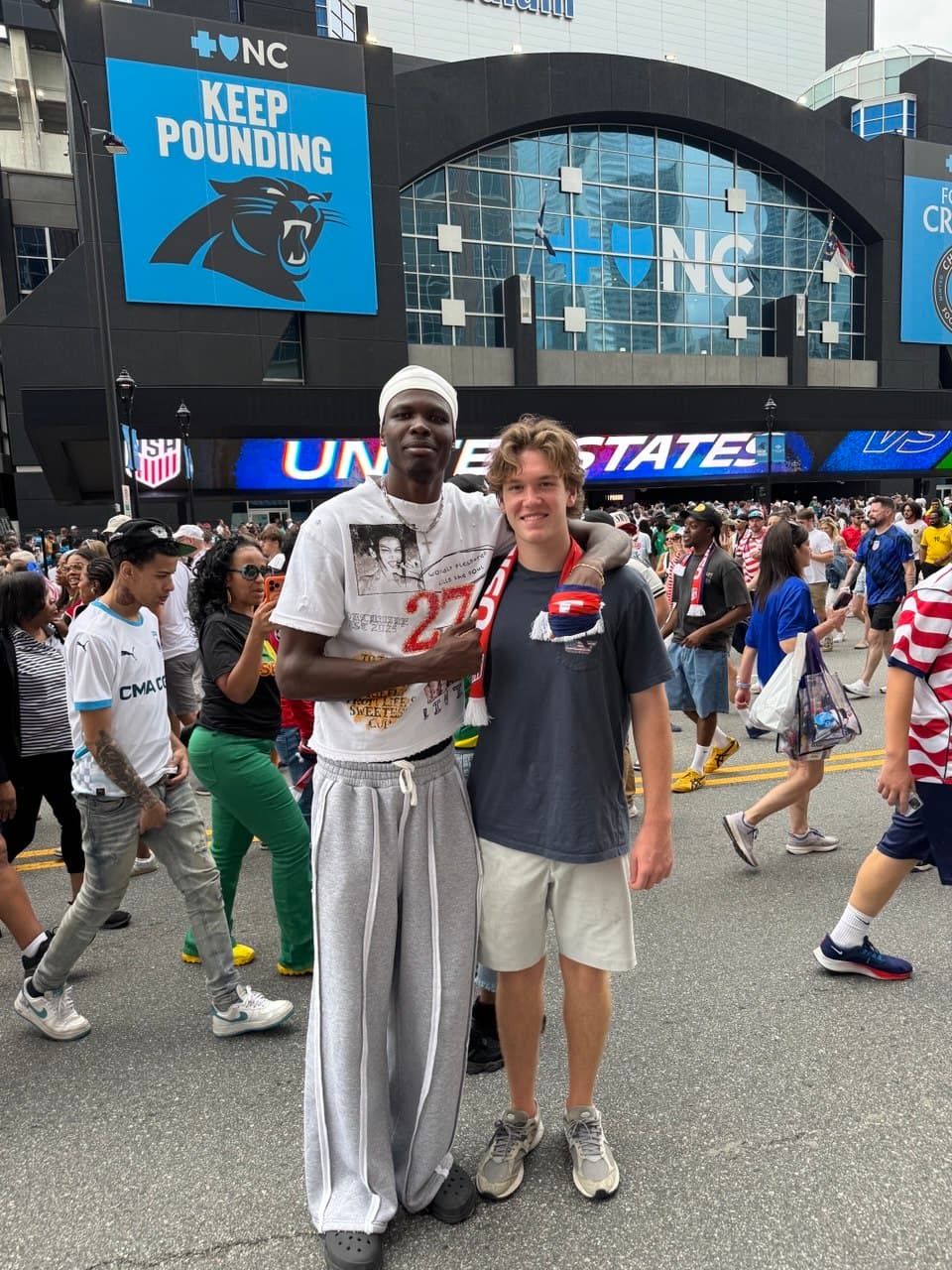 Tichyque and Nick outside a U.S. national team soccer match in Charlotte, Tichyque's arm around his younger brother.